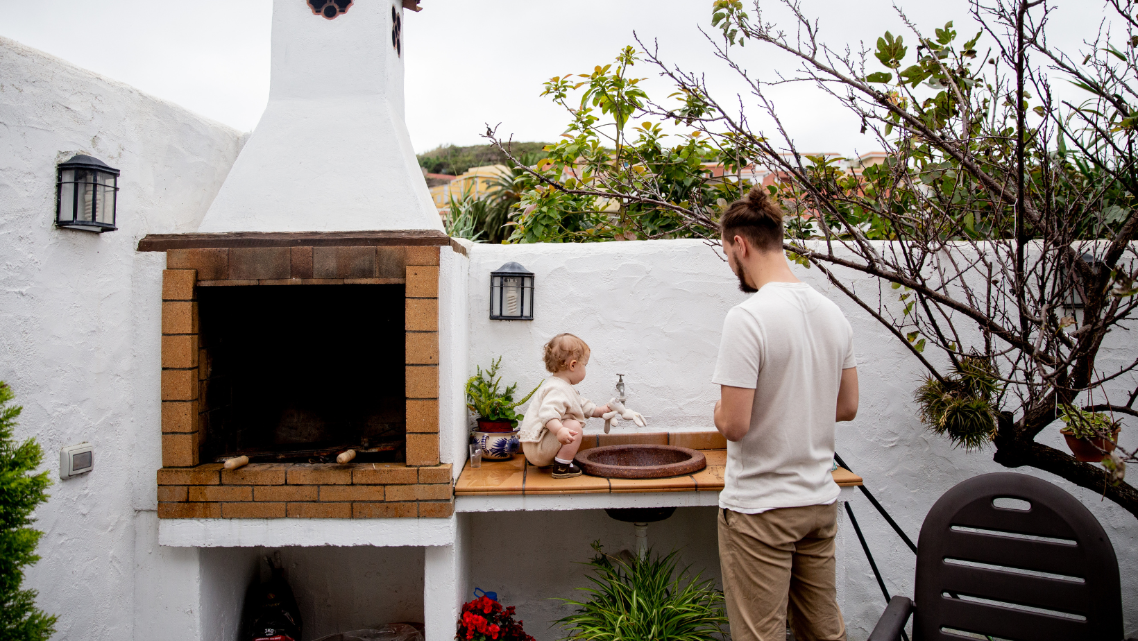 Outdoor kitchen with dad and toddler