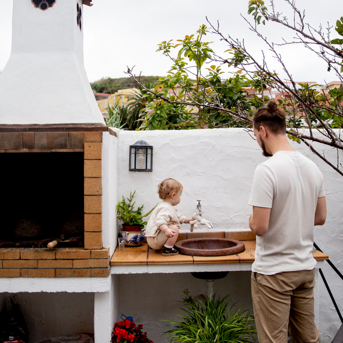 Outdoor kitchen with dad and toddler